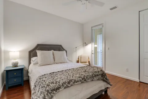 a bedroom with a bed and wooden floor