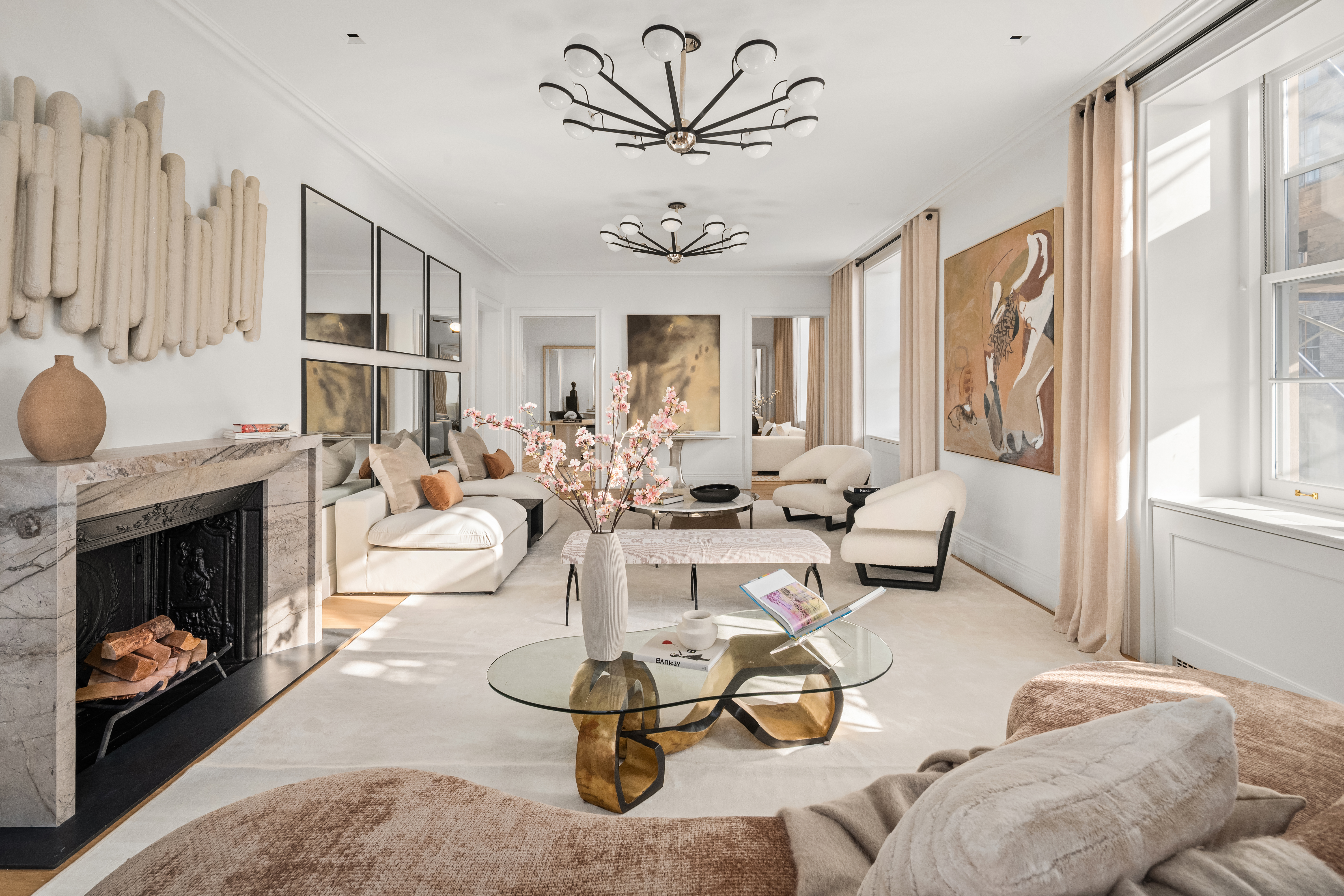 1020 5th Avenue, Unit 9 Manhattan, NY 10028 - Photo 2 of 27 a living room with furniture a fireplace and decor