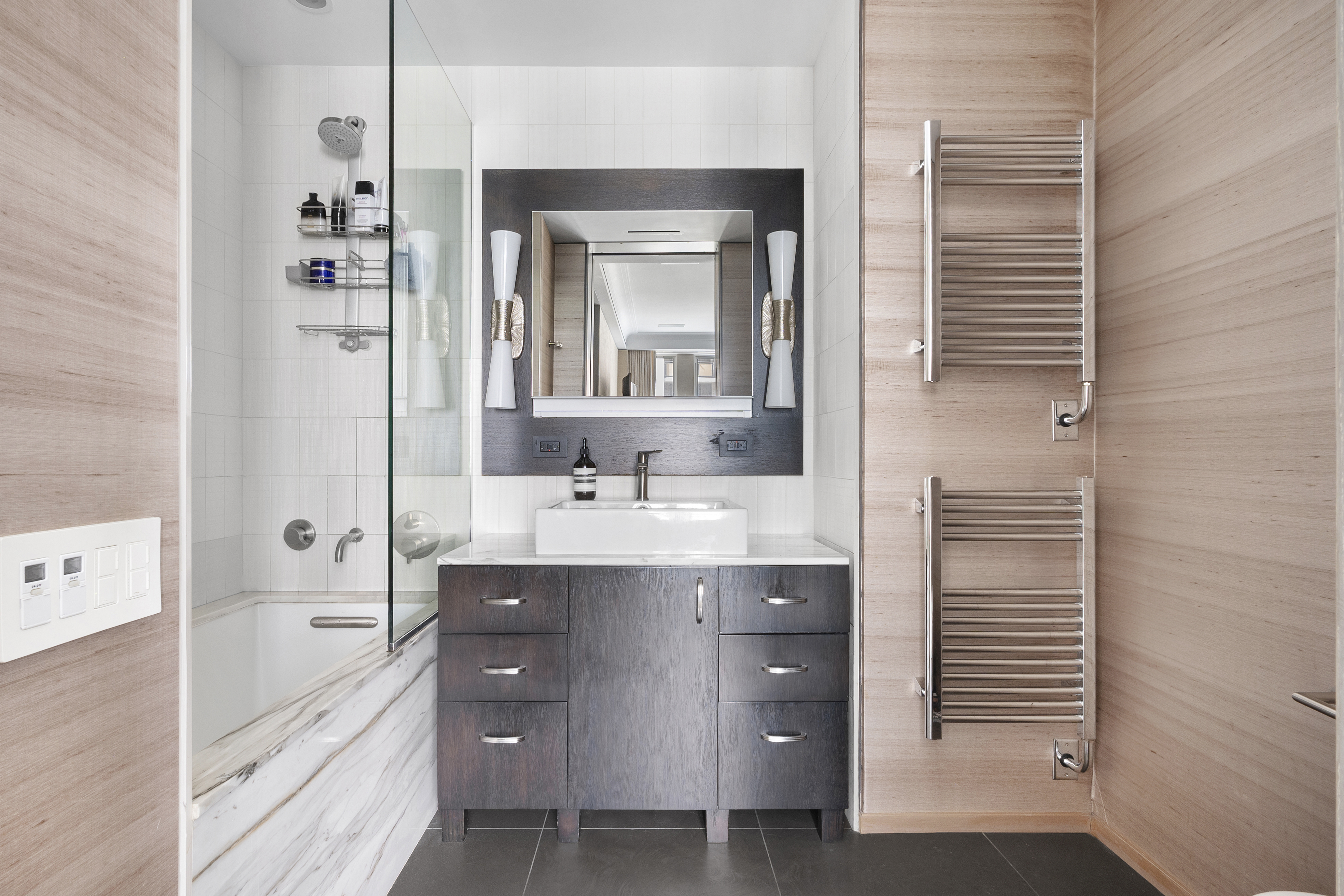 20 West 72nd Street, Unit 500 Manhattan, NY 10023 - Photo 6 of 12 a bathroom with a double vanity sink a mirror and a bathtub