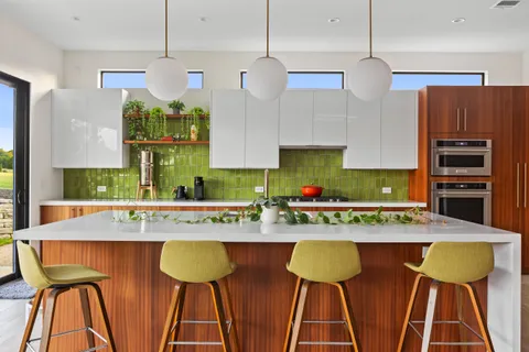 an open kitchen with a table and chairs