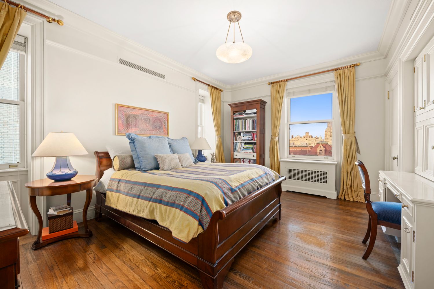 a spacious bedroom with a bed and wooden floor