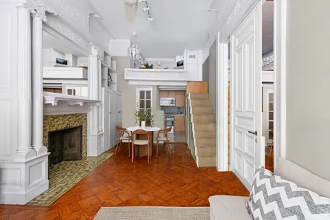 a living room with furniture a fireplace and a table
