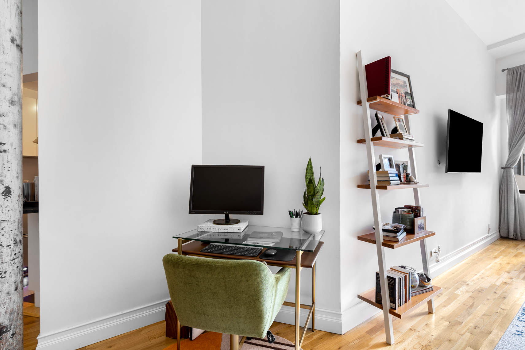 77 Bleecker Street, Unit 819 Manhattan, NY 10012 - Photo 5 of 9 a view of a workspace with furniture and wooden floor