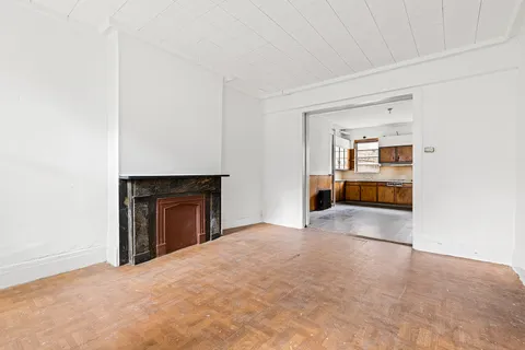 a view of empty room with a fireplace