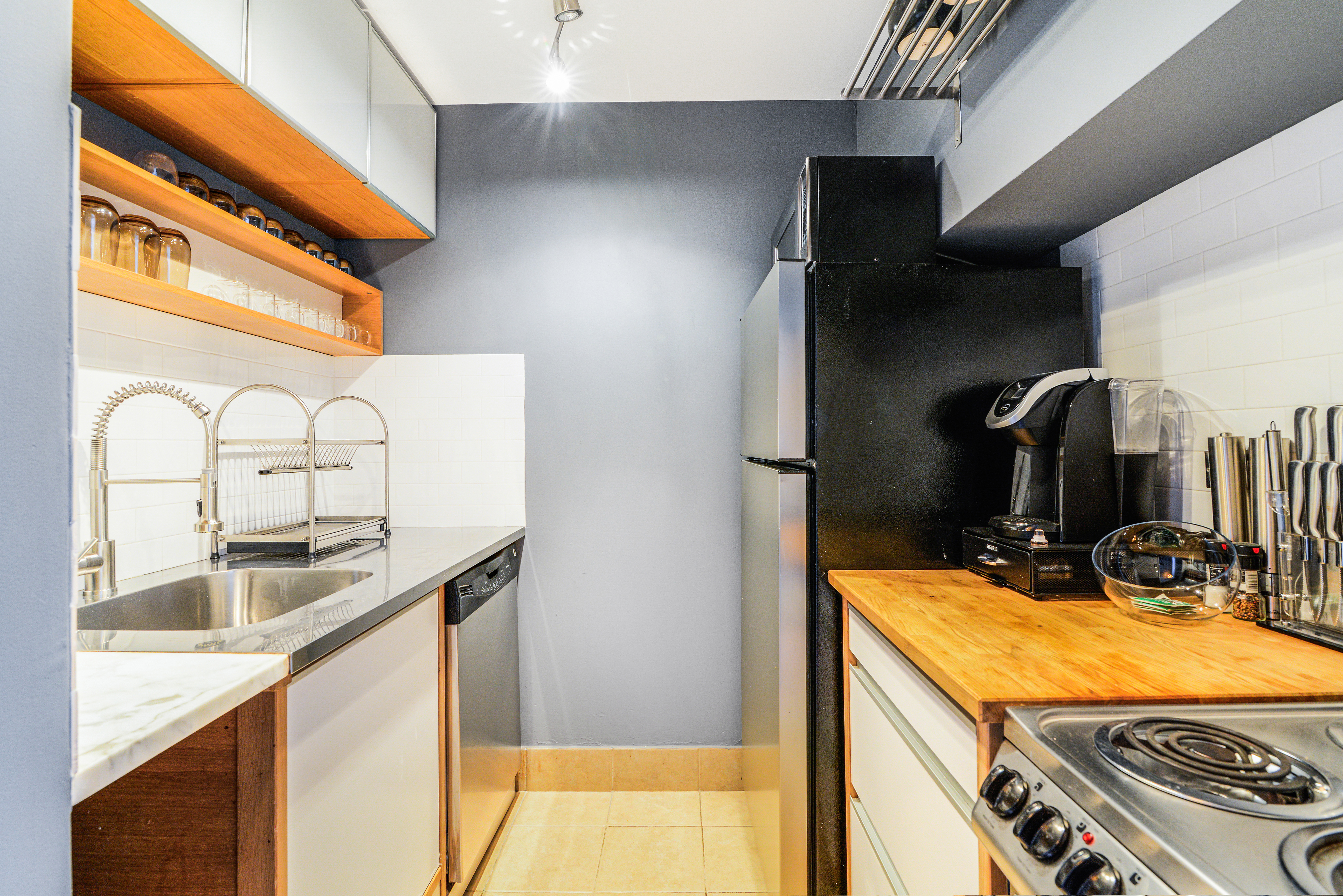 244 Madison Avenue, Unit 15J Manhattan, NY 10016 - Photo 6 of 11 a kitchen with a sink and a refrigerator