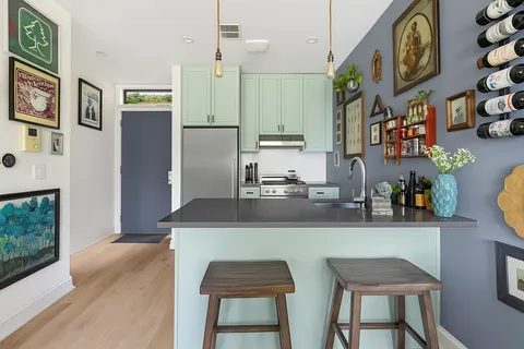 a kitchen with stainless steel appliances granite countertop a sink and a refrigerator