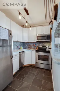 a kitchen with stainless steel appliances a refrigerator sink and microwave