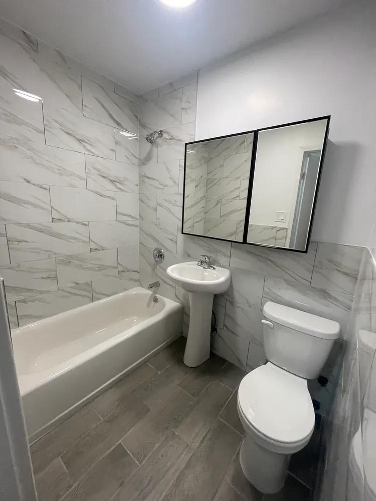 a bathroom with a toilet sink and shower