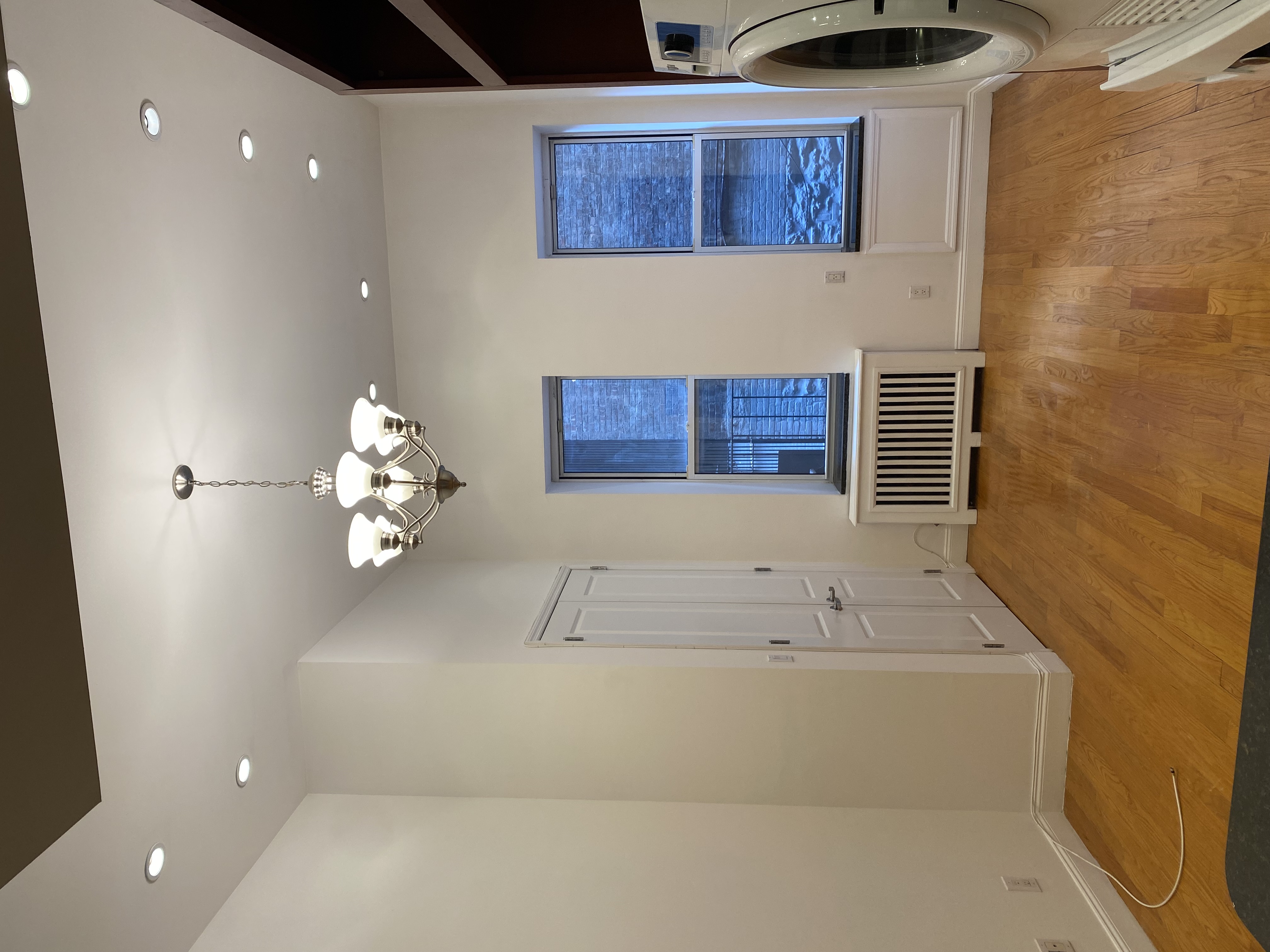1736 2nd Avenue, Unit DB Manhattan, NY 10128 - Photo 6 of 7 a view of a livingroom with a chandelier fan and a window