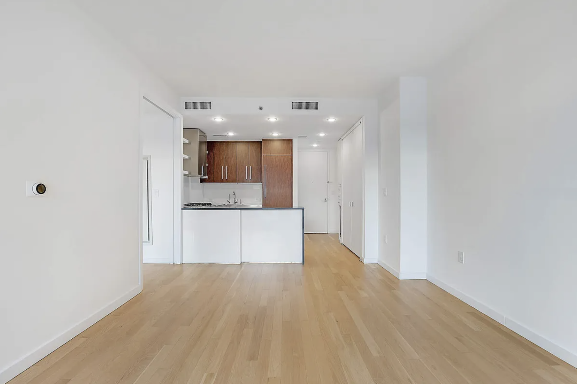 133 West 22nd Street, Unit 7H Manhattan, NY 10011 - Photo 5 of 22 a view of a kitchen with a sink and a refrigerator
