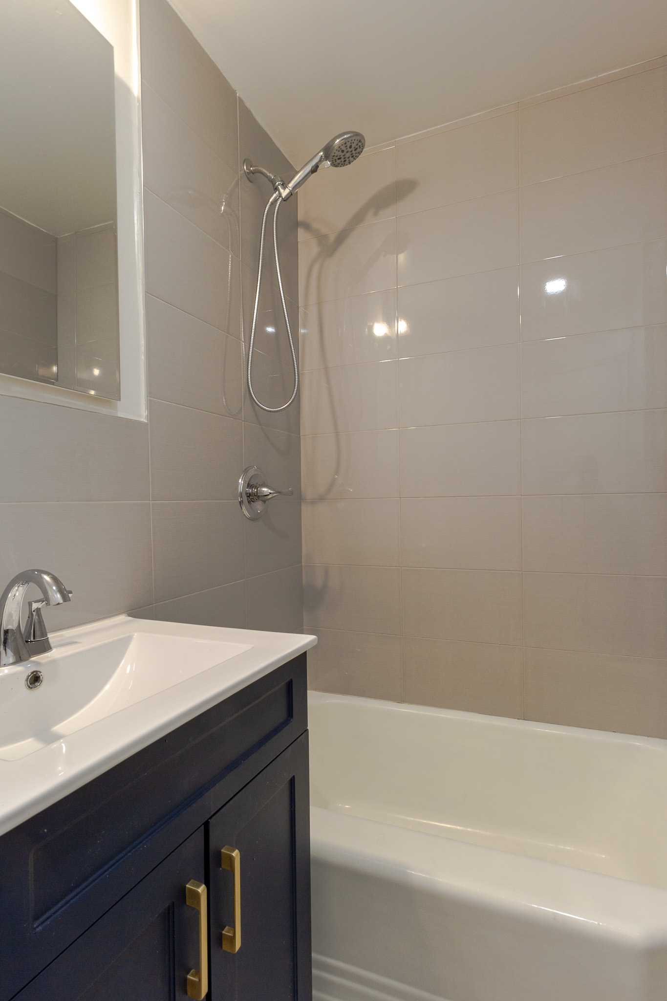 312 Prospect Avenue, Unit 2R Brooklyn, NY 11215 - Photo 9 of 10 a bathroom with a sink a mirror and a bathtub