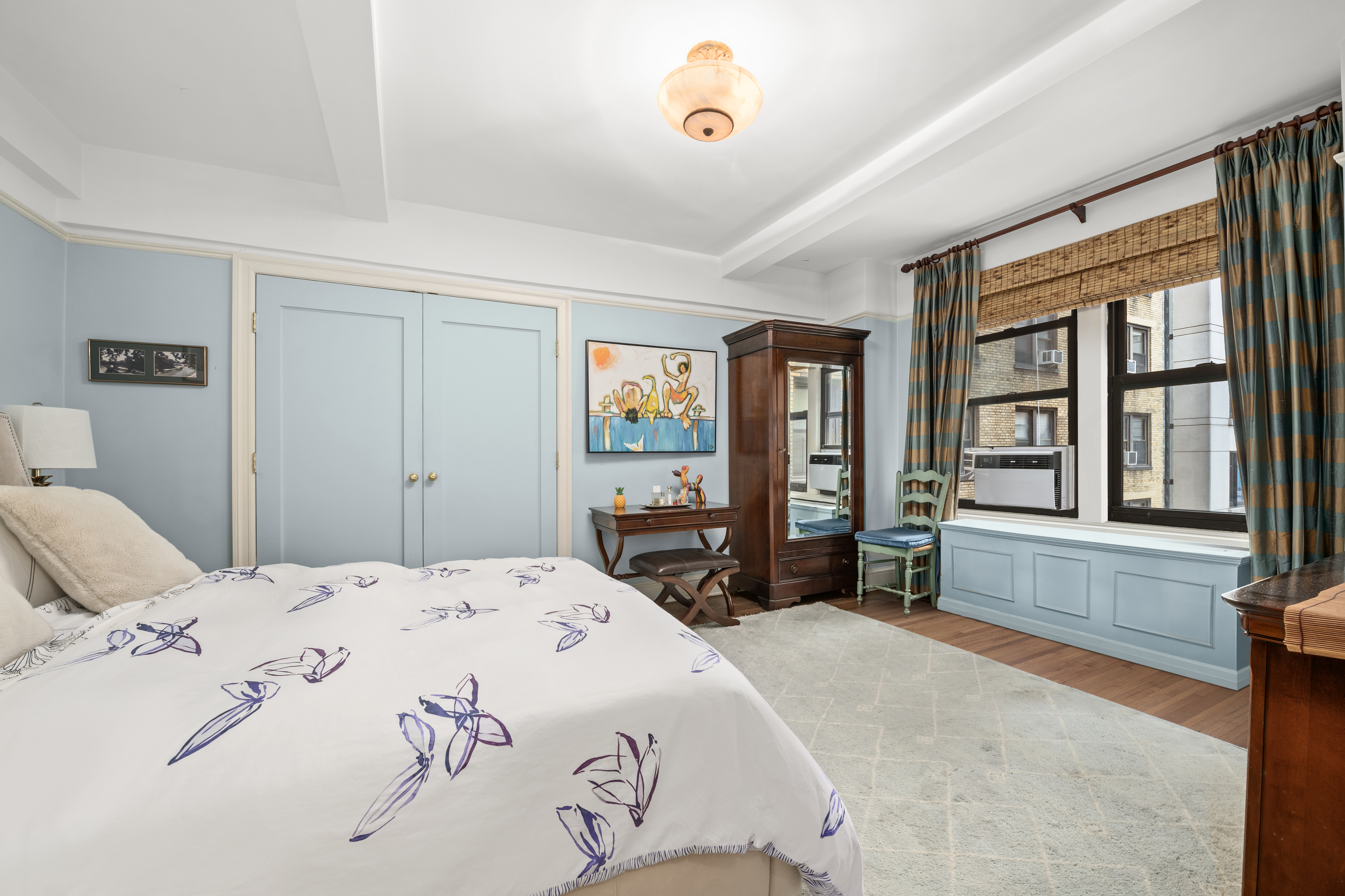 205 East 78th Street, Unit 12J Manhattan, NY 10075 - Photo 5 of 9 a bedroom with a large bed and a large window