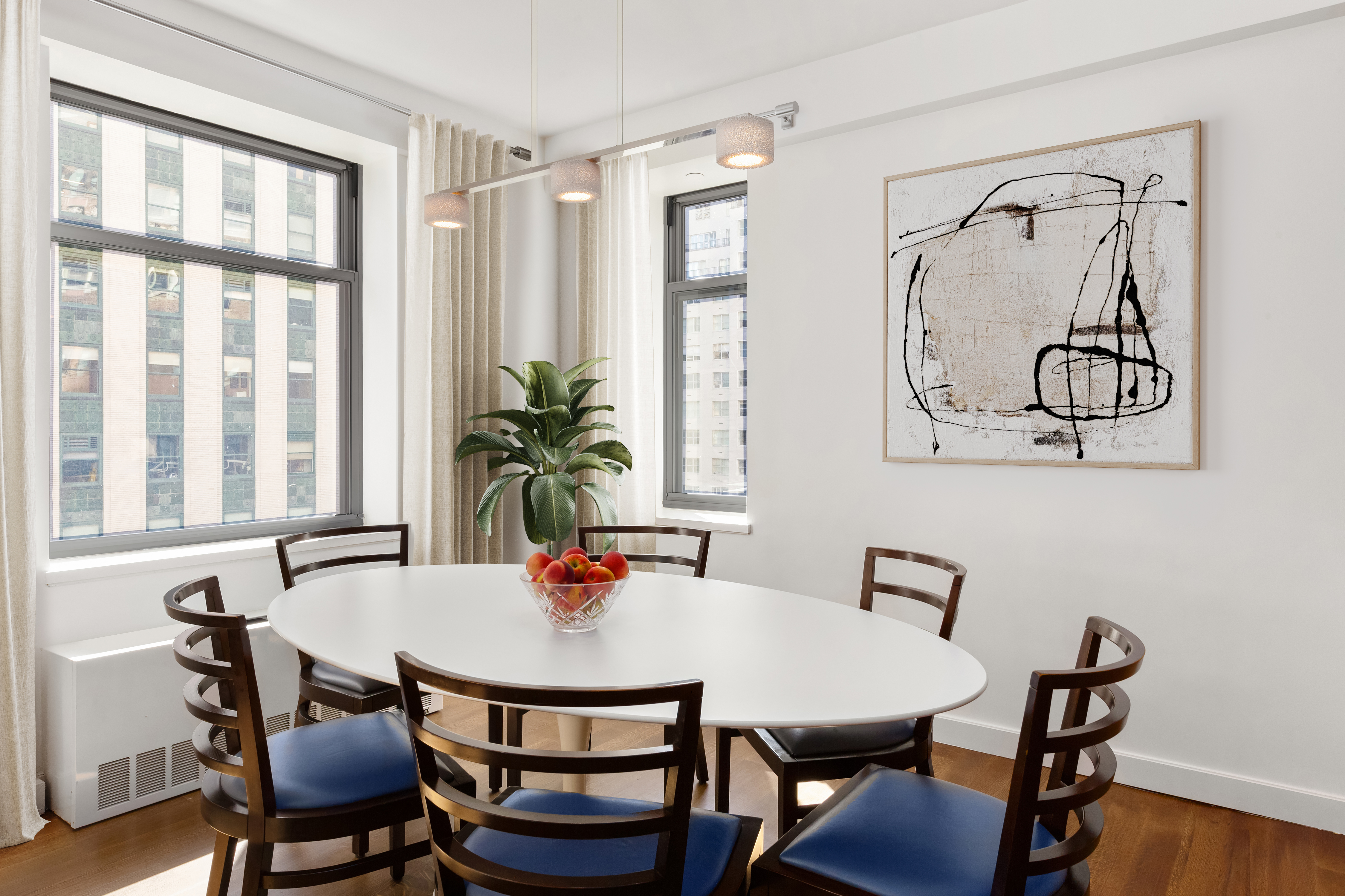 100 West 58th Street, Unit 9B Manhattan, NY 10019 - Photo 3 of 8 a view of a dining room with furniture and window