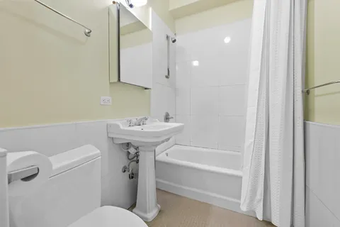 a bathroom with a sink a toilet and mirror