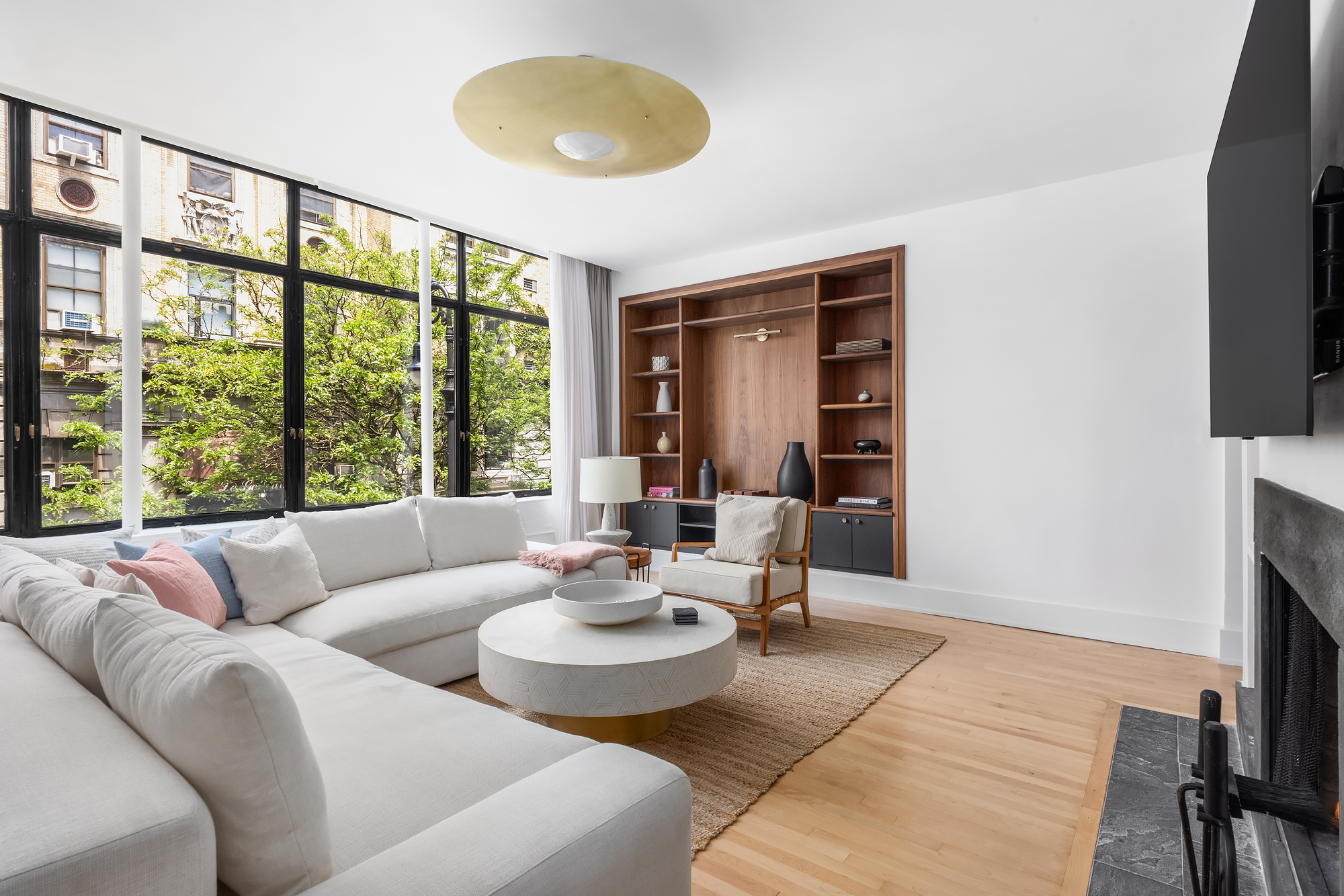 134 Charles Street Manhattan, NY 10014 - Photo 5 of 10 a living room with furniture and a flat screen tv