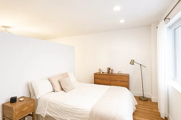 61 Lexington Avenue, Unit 4H Manhattan, NY 10010 - Photo 2 of 6 a bedroom with a bed and a chair