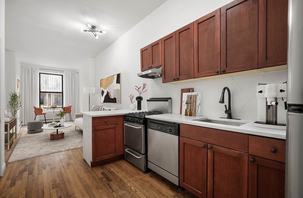 a kitchen with stainless steel appliances sink refrigerator and cabinets