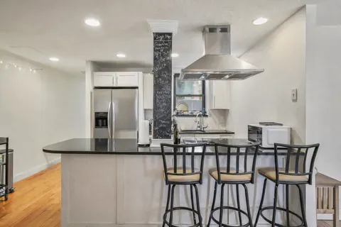 a kitchen with stainless steel appliances a refrigerator sink and cabinets