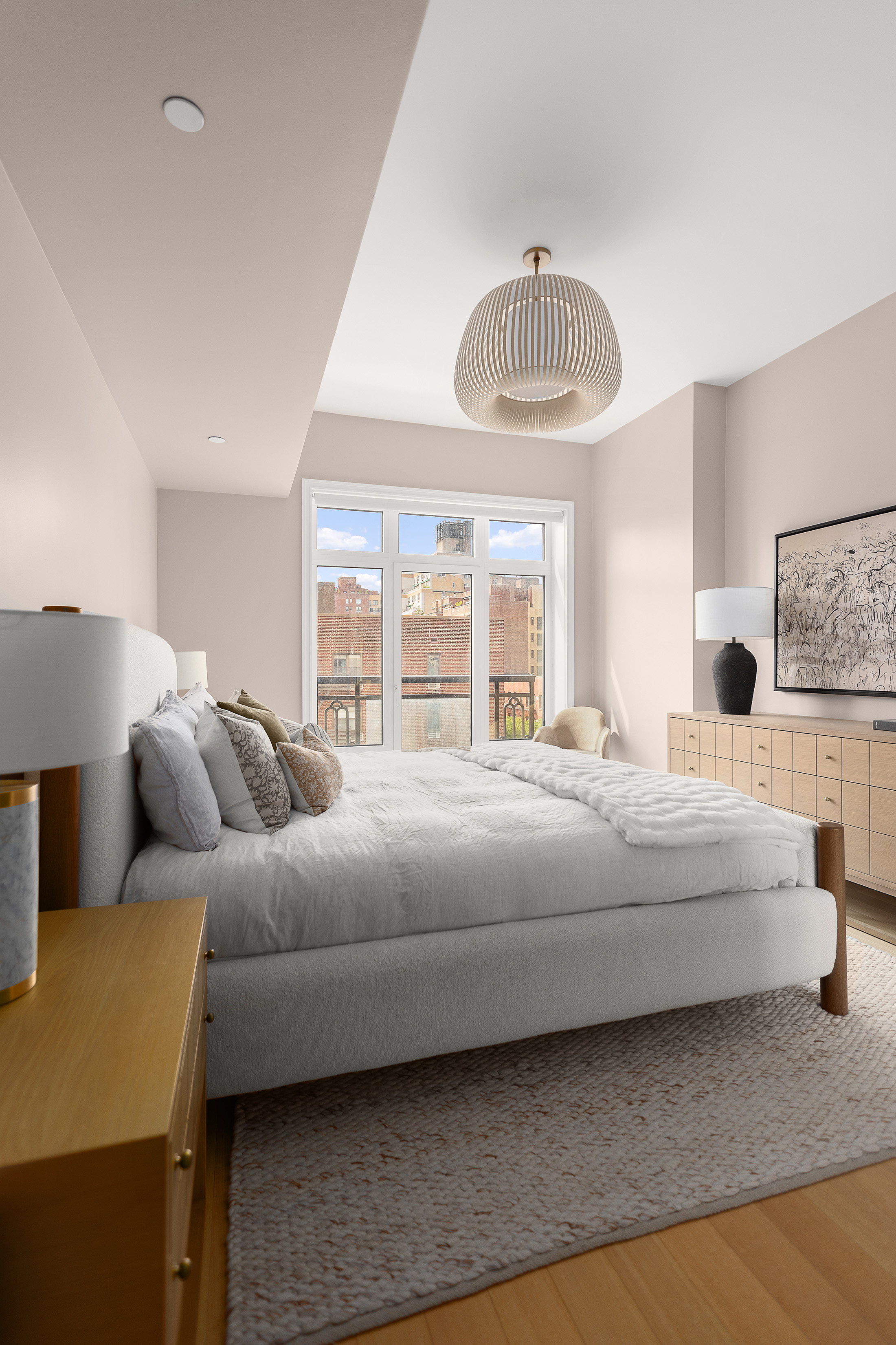 200 East 83rd Street, Unit 8C Manhattan, NY 10028 - Photo 10 of 26 a bedroom with bed and a large window