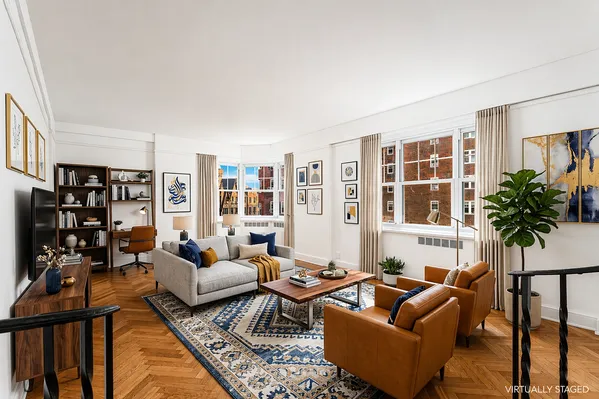 a living room with furniture and a potted plant