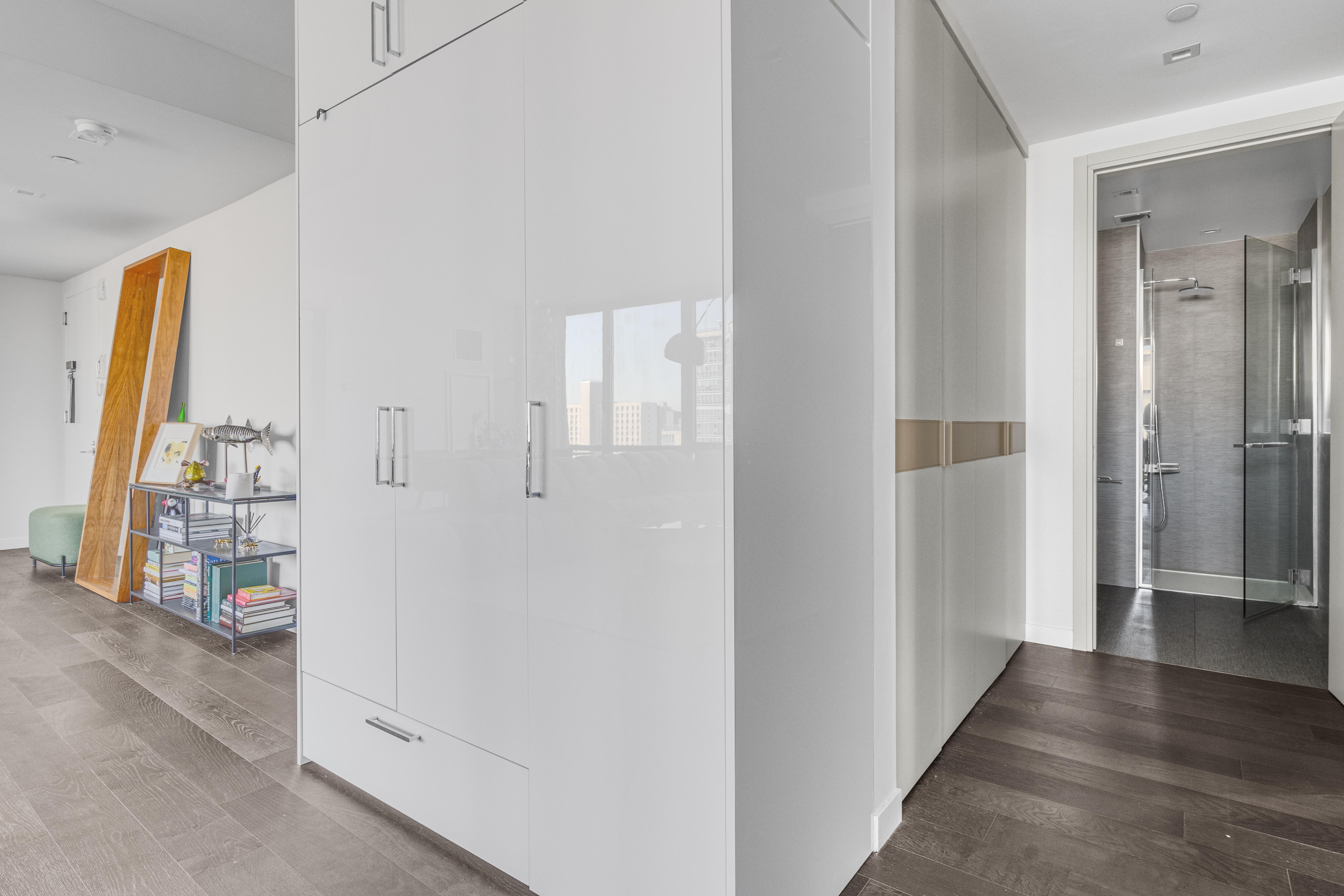 302 East 96th Street, Unit 1103 Manhattan, NY 10128 - Photo 9 of 22 a view of a hallway with wooden floor and cabinet