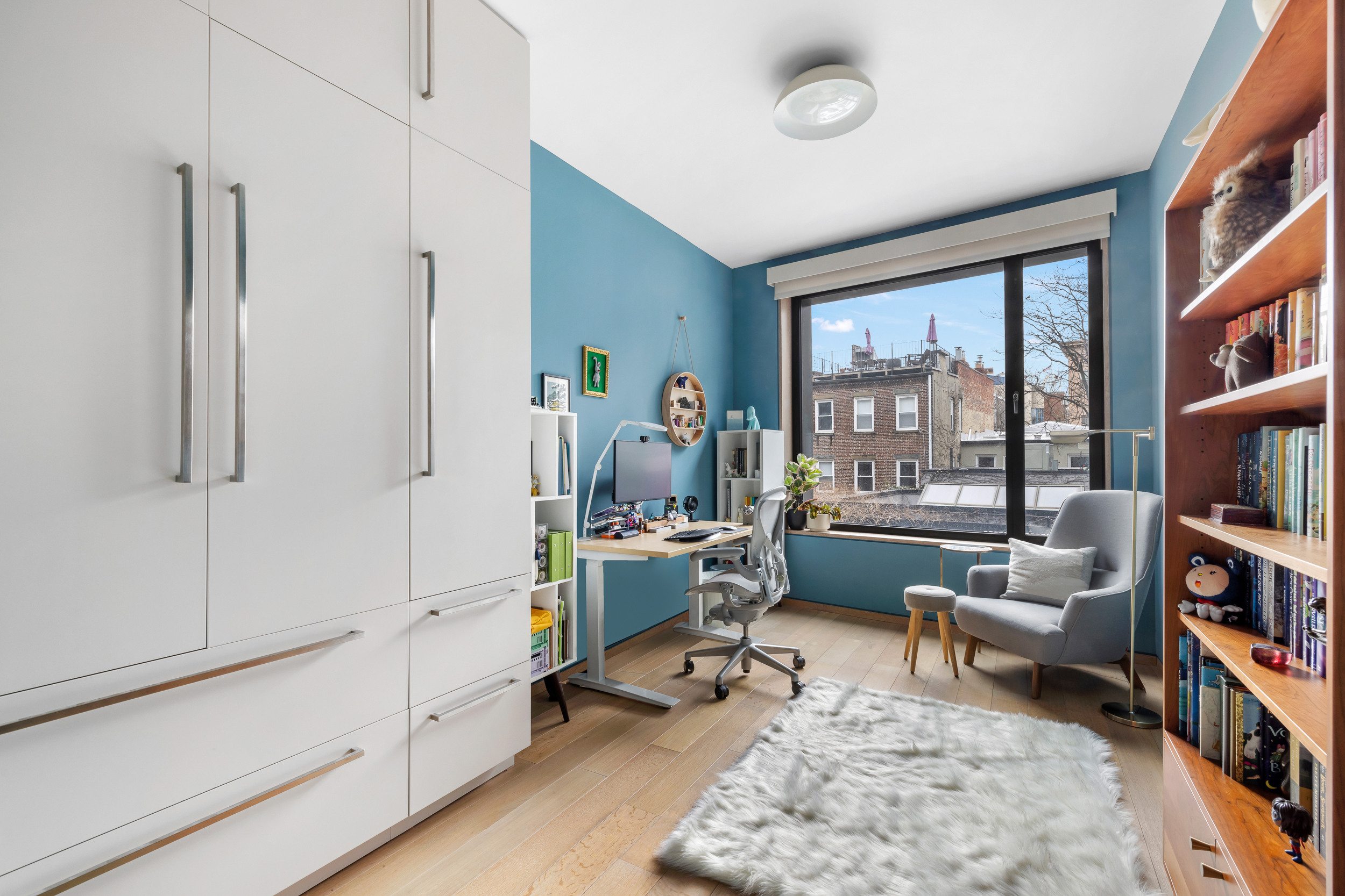 210 Pacific Street, Unit 3E Brooklyn, NY 11201 - Photo 8 of 14 a living room with furniture and a book shelf