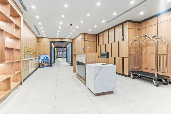 a living room with stainless steel appliances furniture a rug and a large window