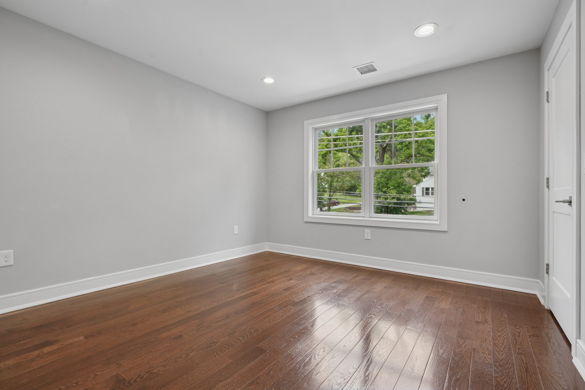 823 River Road Chatham, NJ 07928 - Photo 18 of 60 an empty room with wooden floor and windows