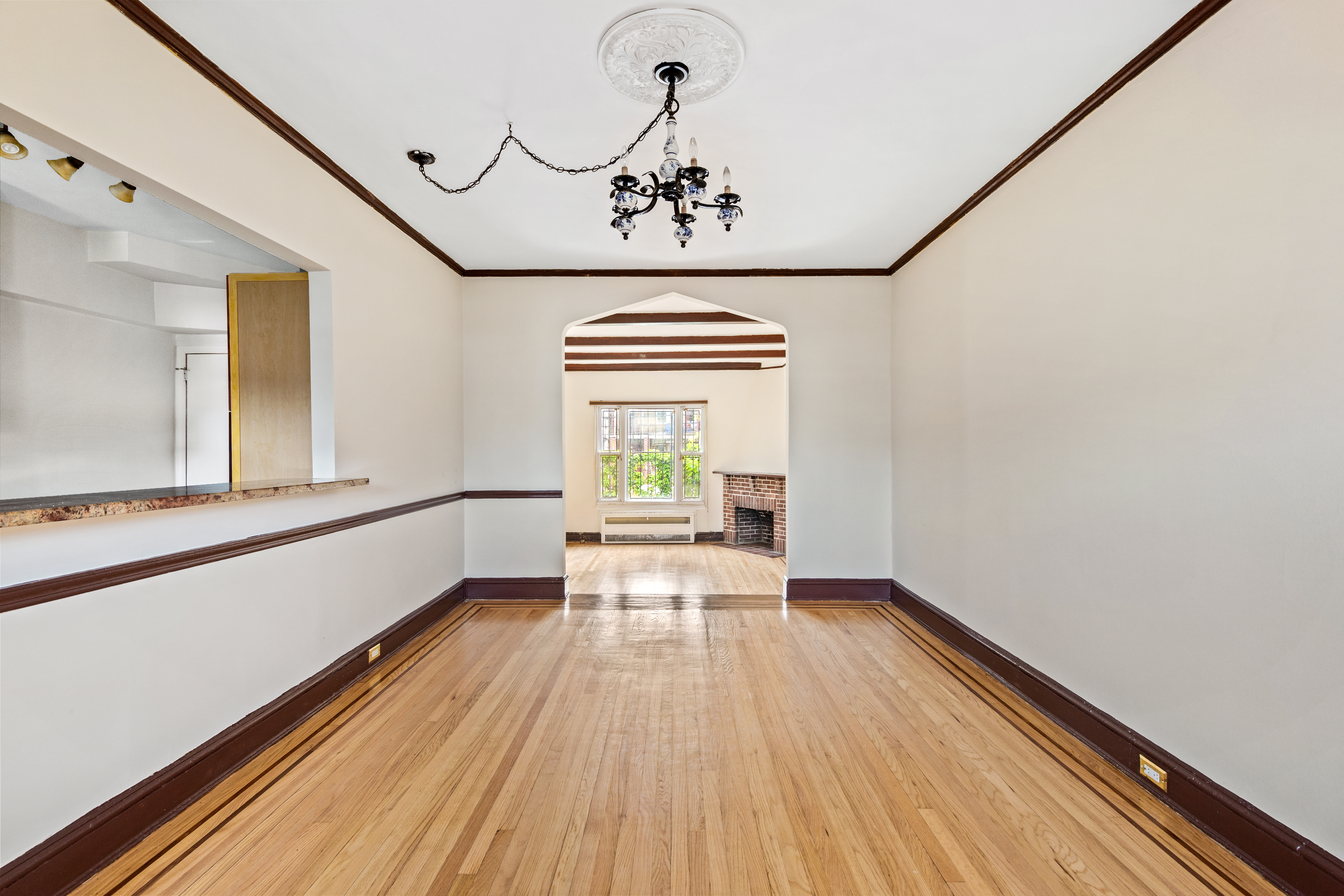32 Tudor Terrace Brooklyn, NY 11224 - Photo 4 of 15 a view of a hallway with wooden floor and chandelier