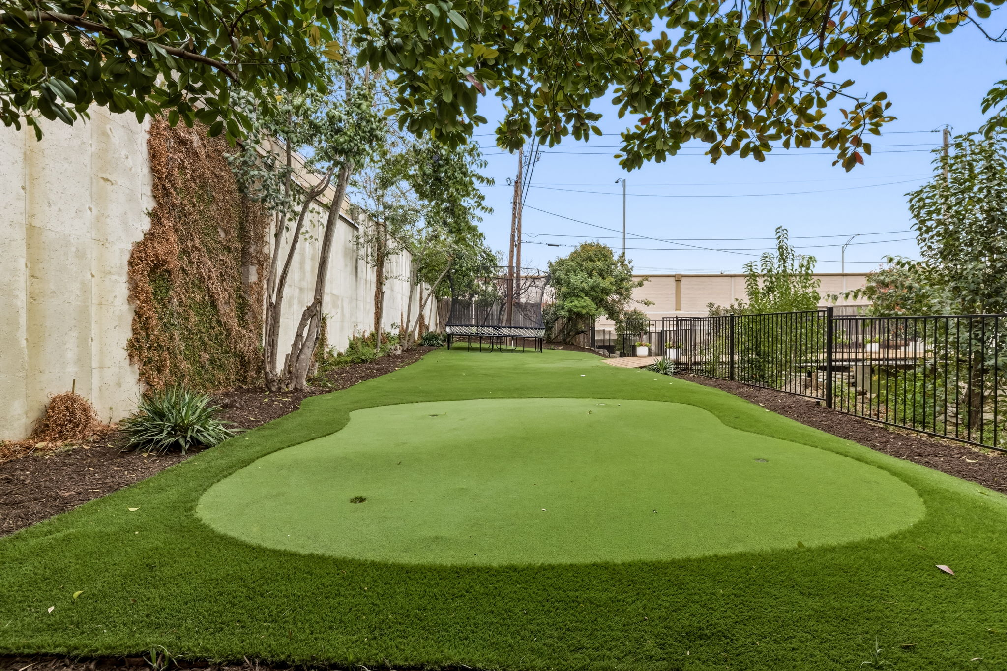 5765 Stonegate Road Dallas, TX 75209 - Photo 36 of 37 a view of a golf course with a garden