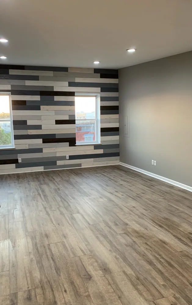 a view of room with wooden floor and windows