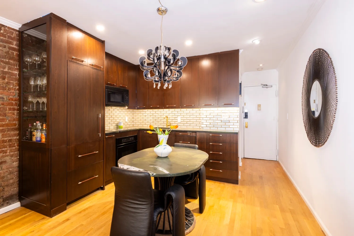 a bathroom with a sink a light fixture and a mirror