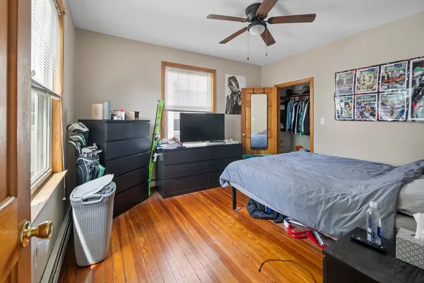 a bed room with a bed window and a flat screen tv