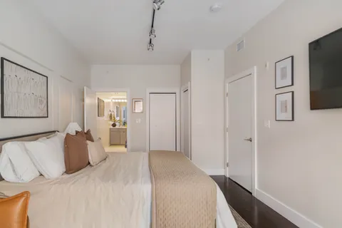 a bedroom with a bed and a flat screen tv