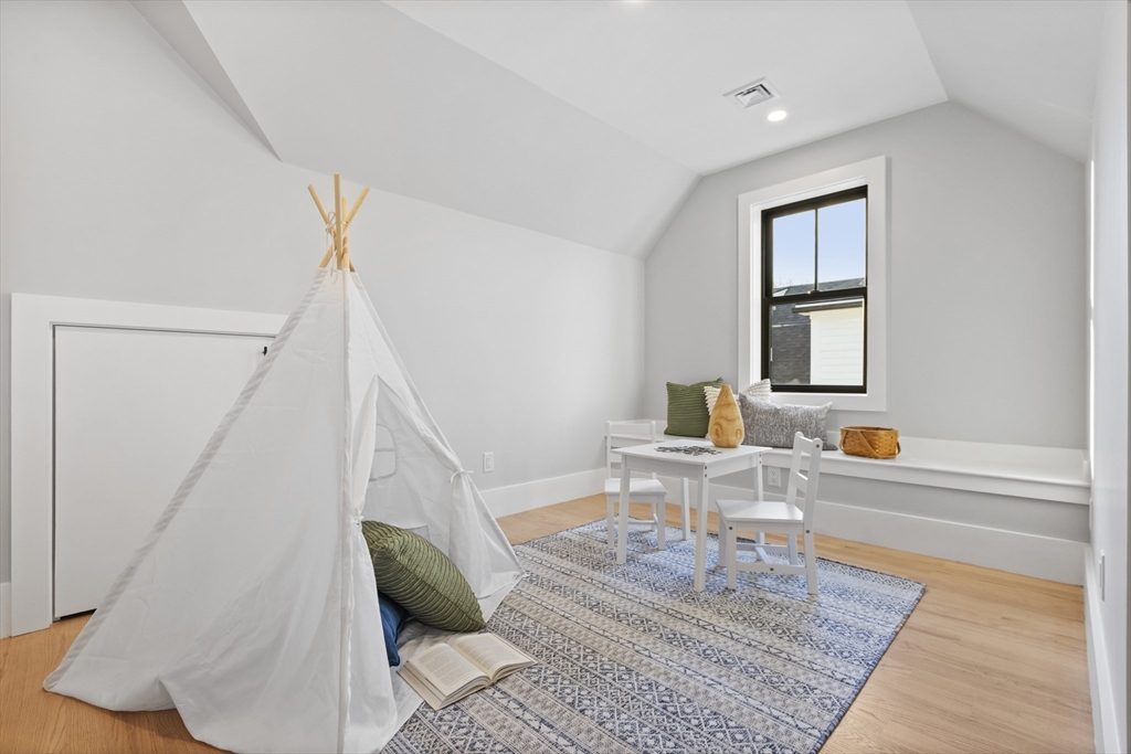 10 Webber Avenue, Unit 3C Bedford, MA 01730 - Photo 21 of 36 a living room with furniture and a rug