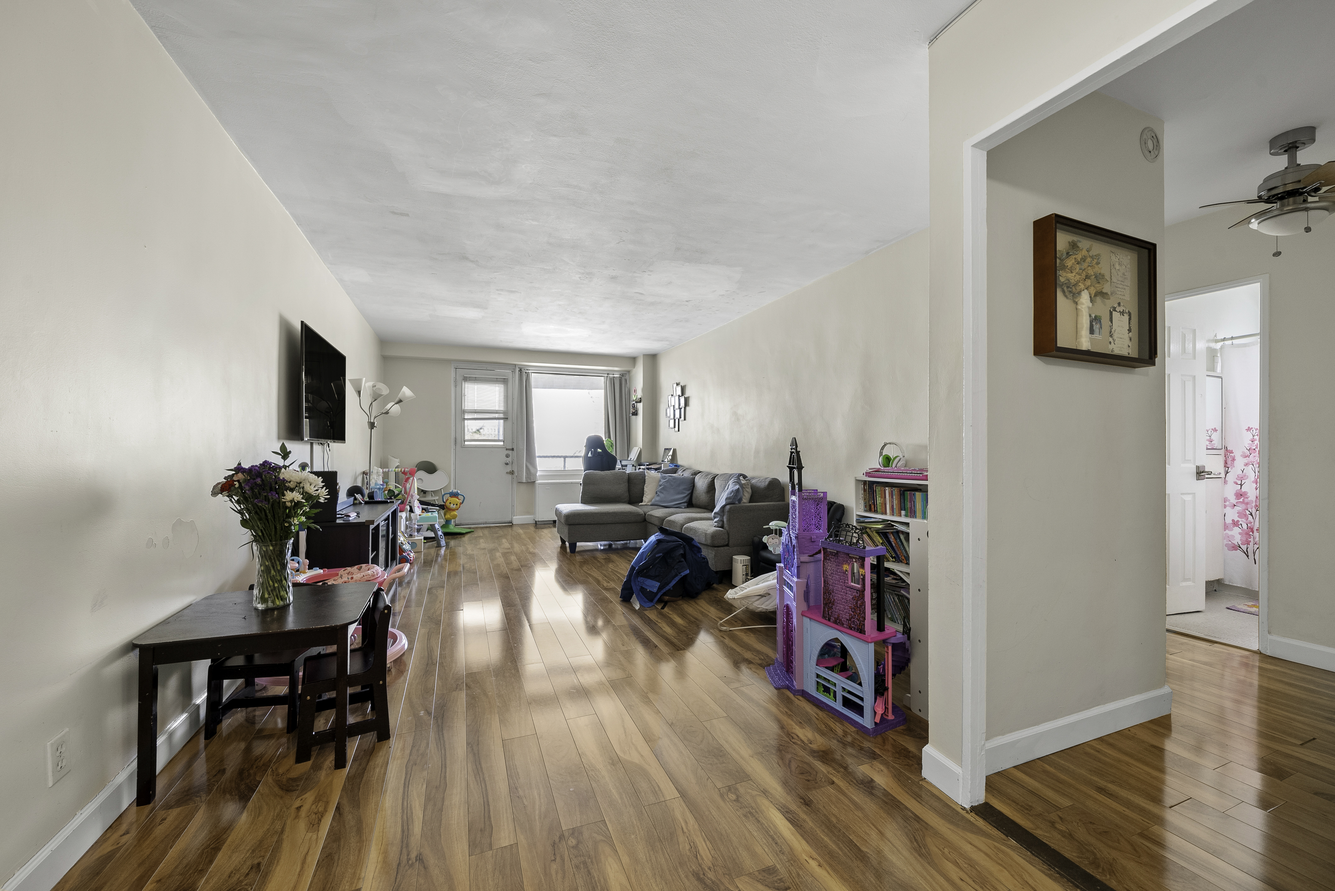 1020 Grand Concourse, Unit 5G Bronx, NY 10451 - Photo 1 of 11 a living room with furniture and a wooden floor