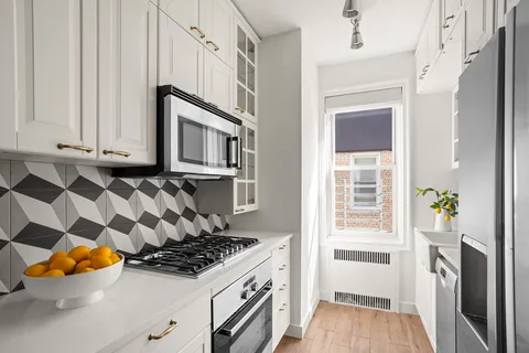 a kitchen with stainless steel appliances granite countertop a stove and a refrigerator