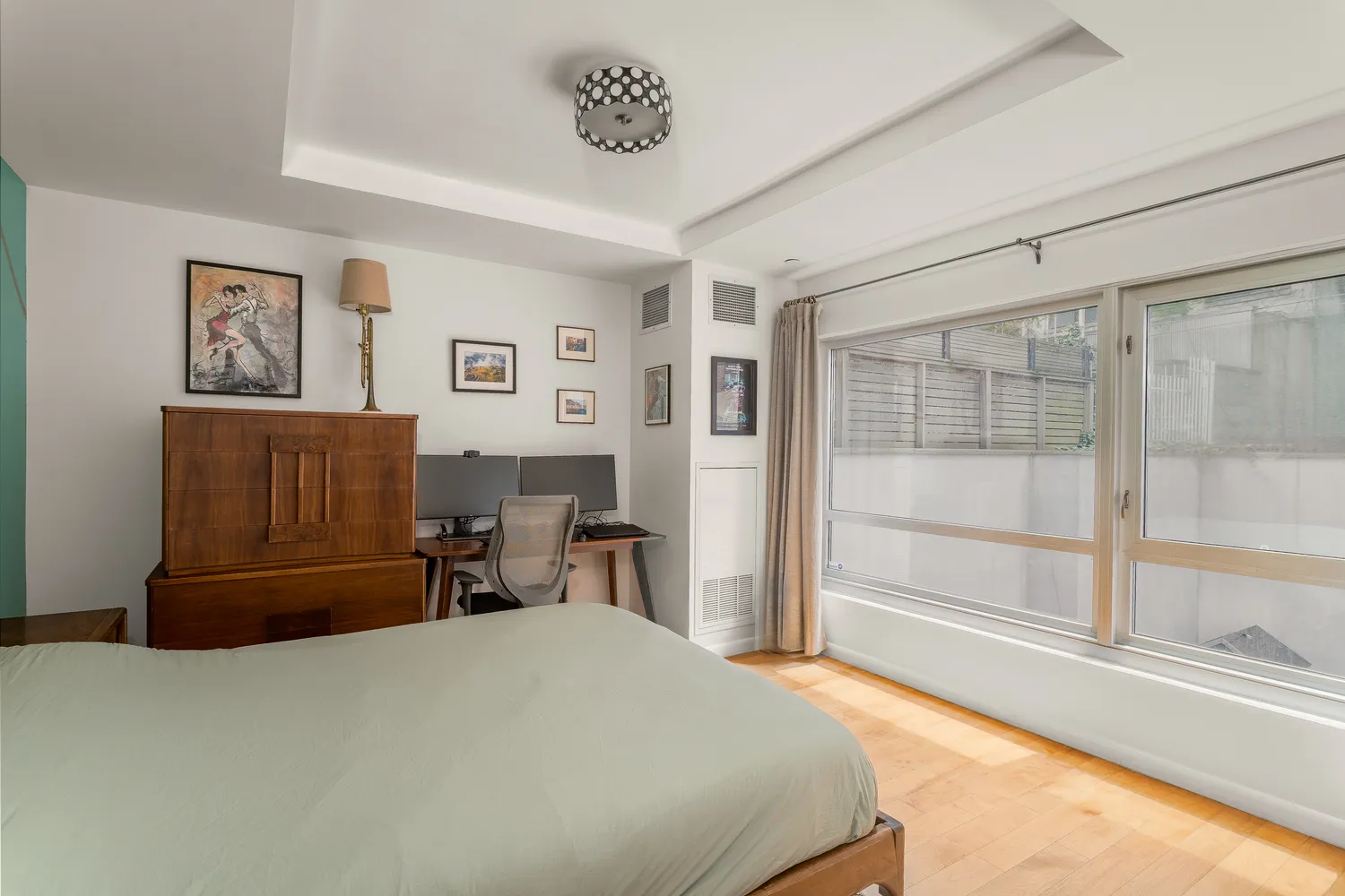 a bedroom with a bed and glass window