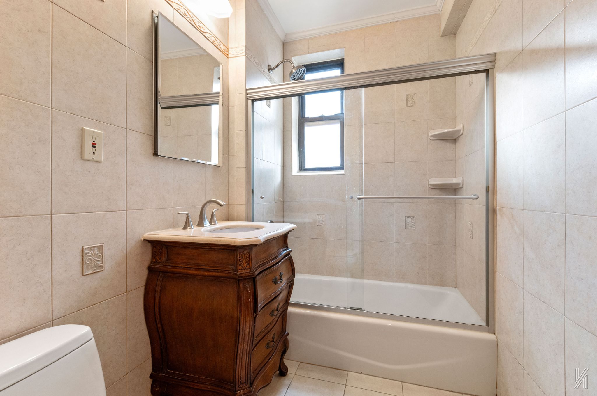 25-40 31st Avenue, Unit 6E Queens, NY 11106 - Photo 13 of 15 a bathroom with a sink a mirror and a bathtub