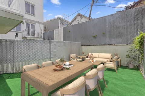 a view of a patio with table and chairs and potted plants