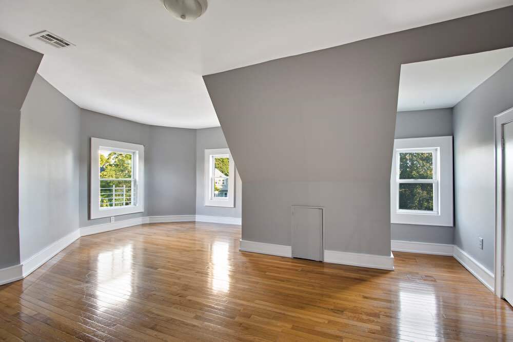 1617 Dorchester Road, Unit 3 Brooklyn, NY 11226 - Photo 1 of 6 a view of an empty room with wooden floor and a window