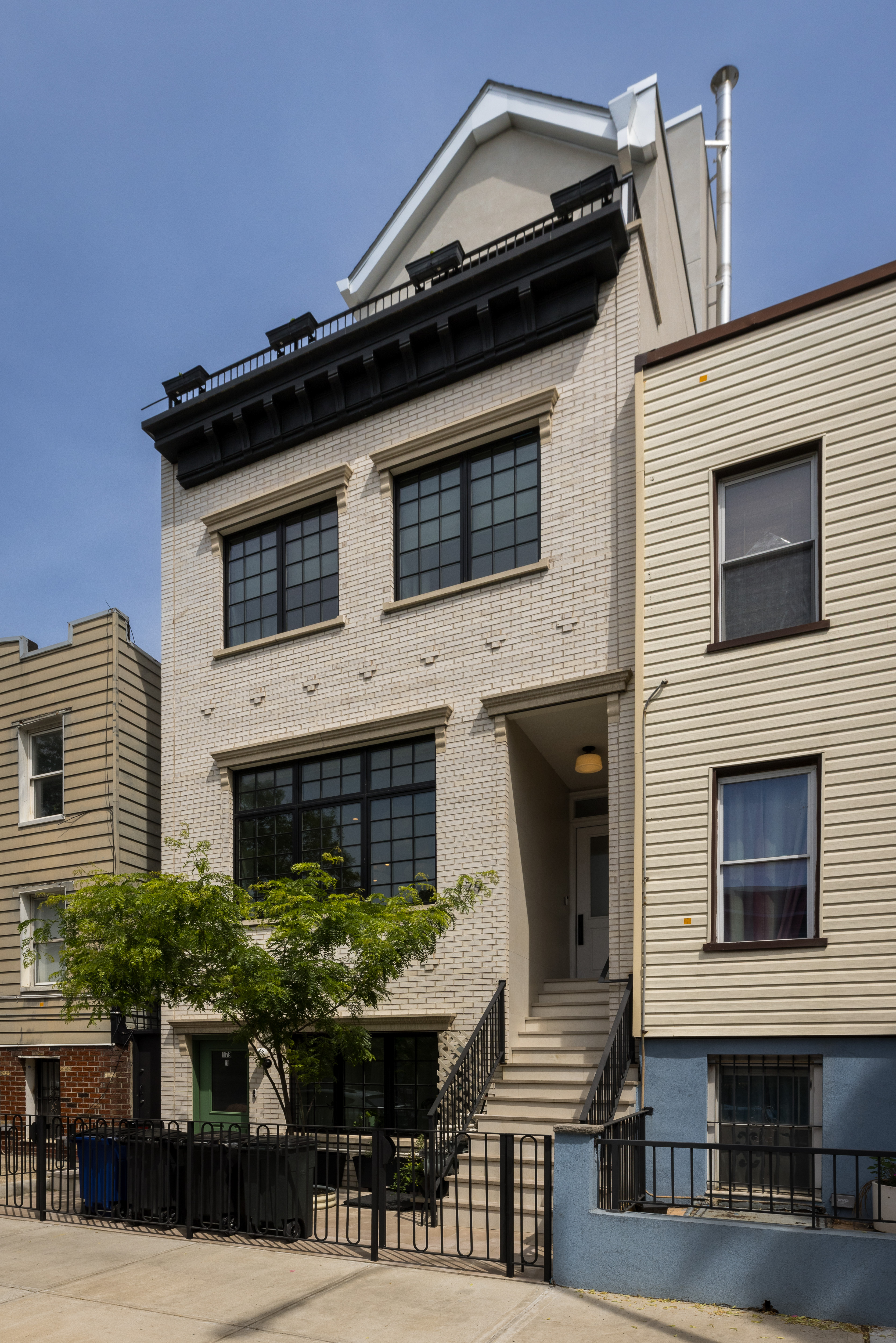 179 Devoe Street Brooklyn, NY 11211 - Photo 19 of 20 a front view of a house with a yard
