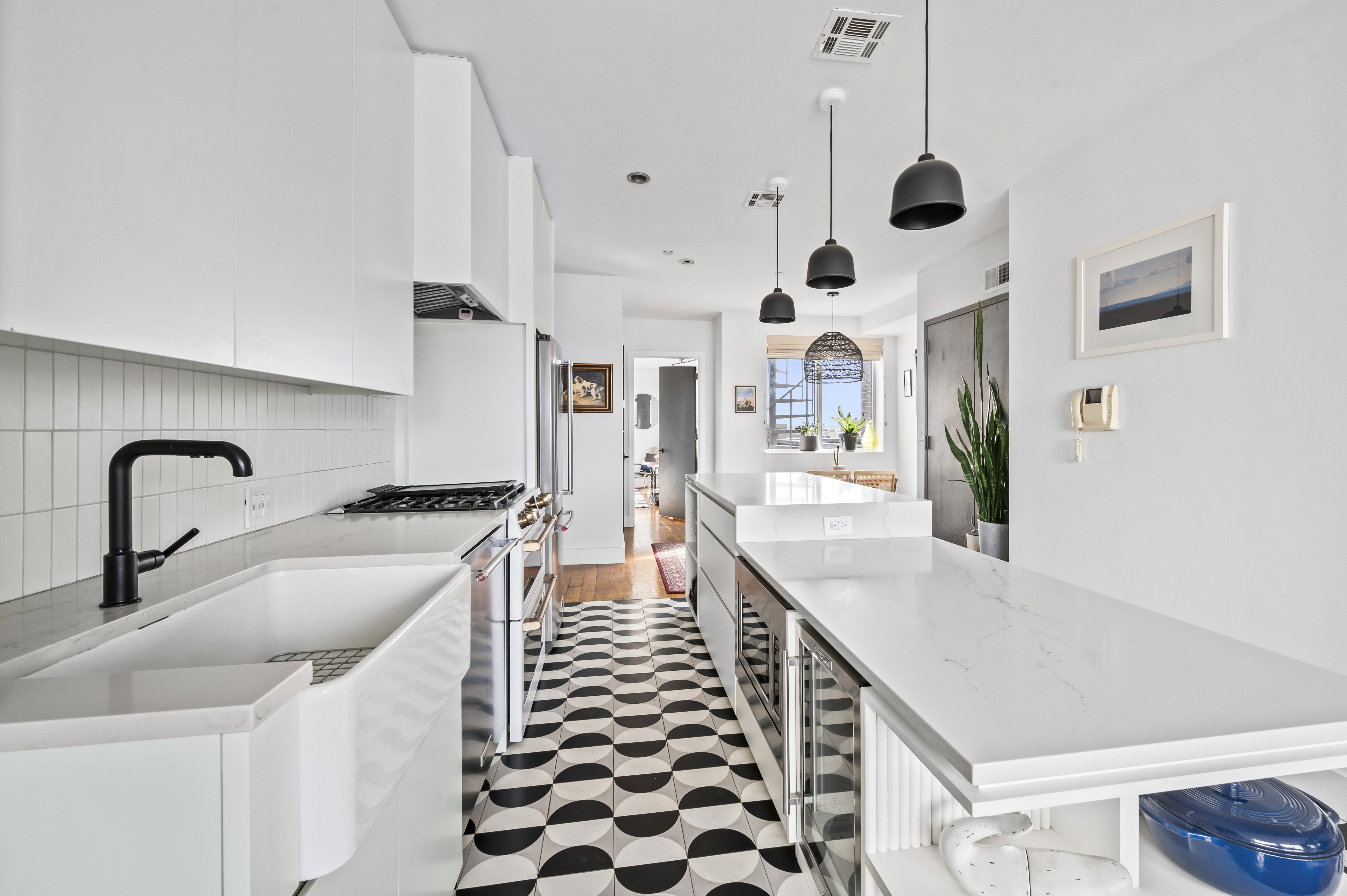 191 Spencer Street, Unit 9A Brooklyn, NY 11205 - Photo 3 of 10 a kitchen with stainless steel appliances a sink and a large window