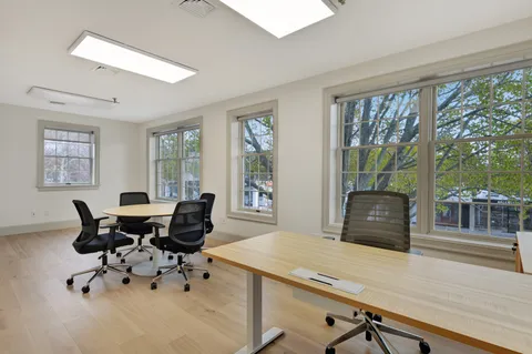 a living room with furniture and large windows