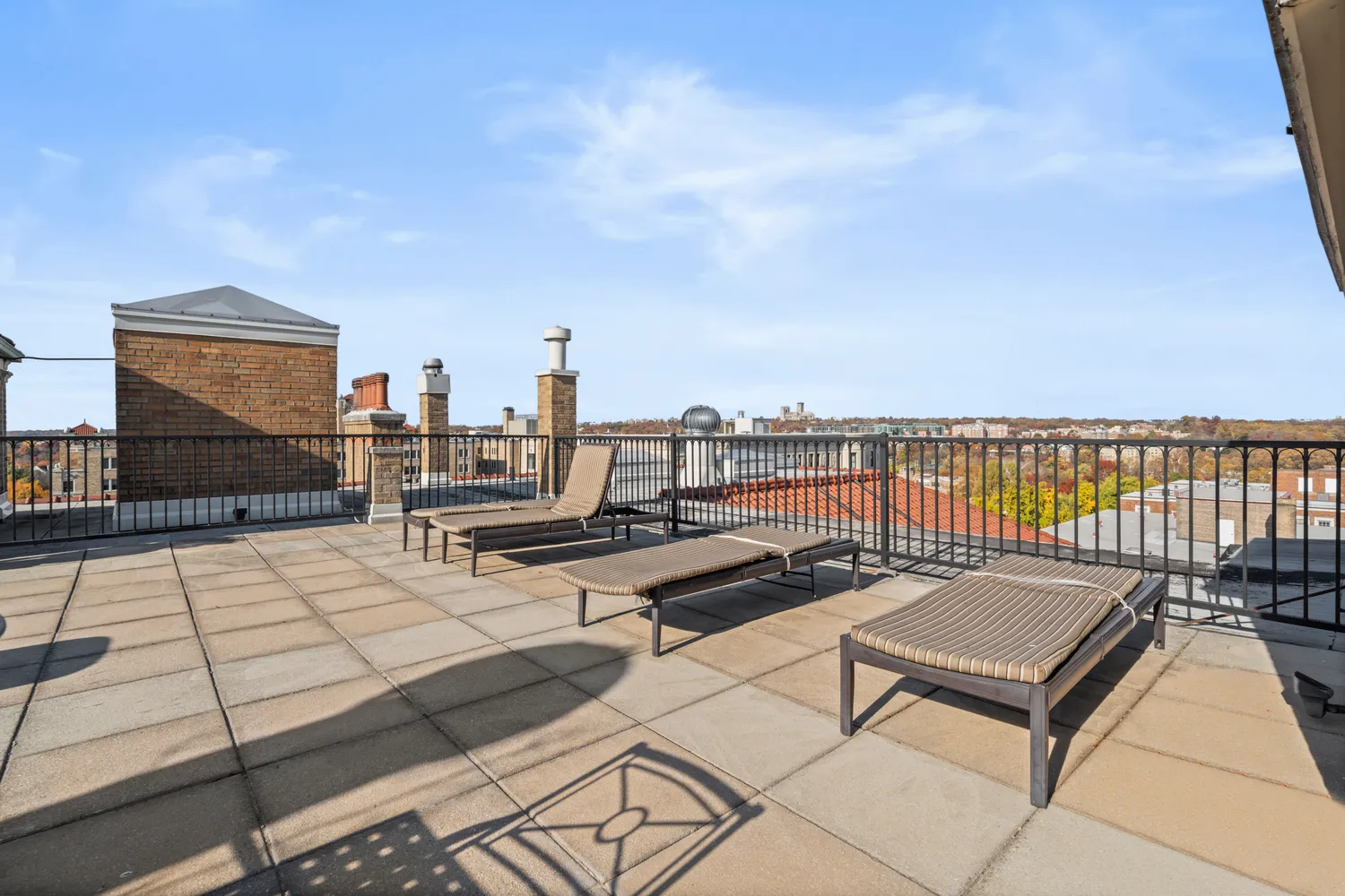 a terrace with outdoor seating and city view