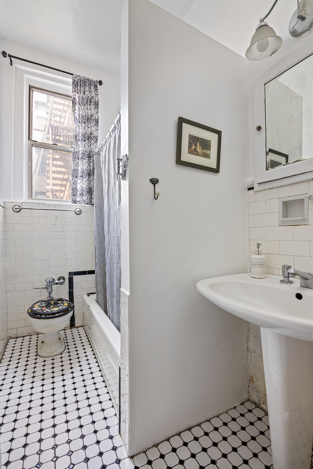 41 Eastern Parkway, Unit 1D Brooklyn, NY 11238 - Photo 13 of 16 a bathroom with a sink toilet and window