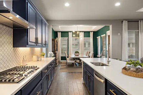 a large kitchen with kitchen island a large window in it