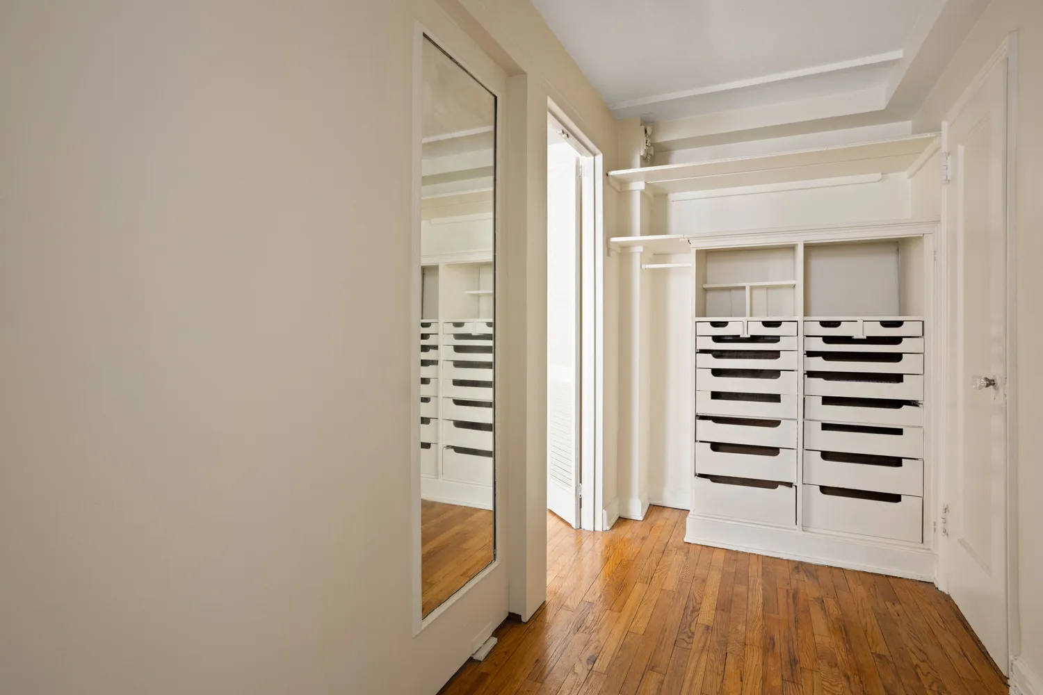 a view of a bedroom with wooden floor