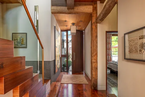 a dining room with furniture and wooden floor