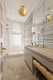 a bathroom with a double vanity sink a mirror and a bathtub